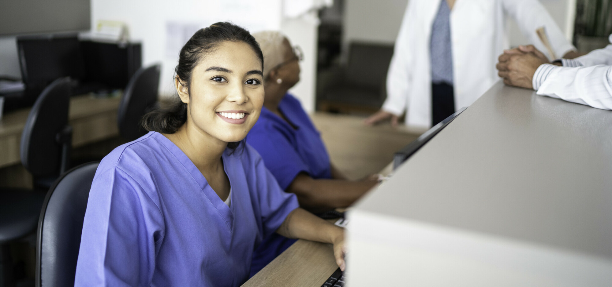 Portrait of secretary working at hospital reception